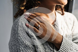 Cheerful woman with engagement ring