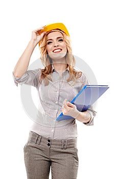 Cheerful woman engineer wearing protection helmet and holding a