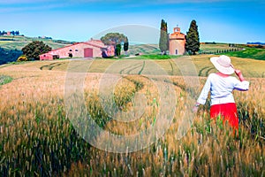 Cheerful woman enjoying the view in grain fields, Tuscany, Italy