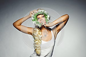 Cheerful woman with a floral wreath with face.