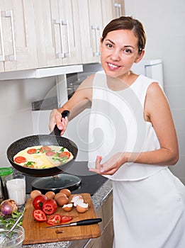 cheerful woman fried eggs