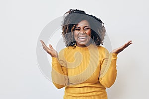 Cheerful woman with frizzy hairstyle dancing against white background