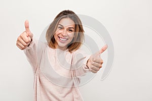 Cheerful woman gesturing thumbs up