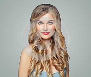 Cheerful woman with healthy curly hairstyle and red lips makeup. Facial treatment, haircare and cosmetology