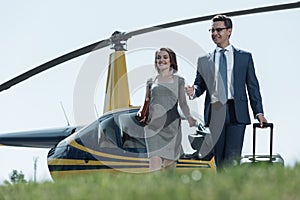 Cheerful woman and her husband leaving helipad