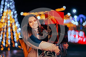 Cheerful Woman Holding Many Christmas Presents Enjoying the Holidays