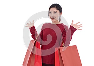 cheerful woman holding red shopping bag isolated on white background