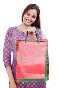 Cheerful woman holding shopping bags