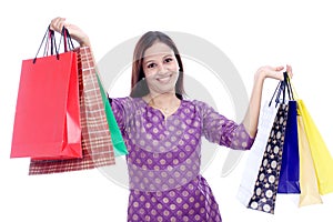 Cheerful woman holding shopping bags