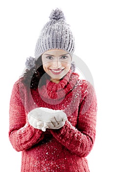 Cheerful woman holding snow on studio