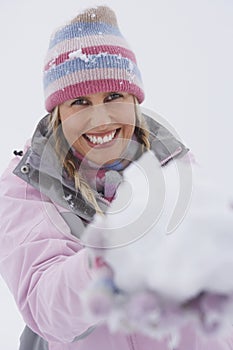 Cheerful Woman Holding Snowball