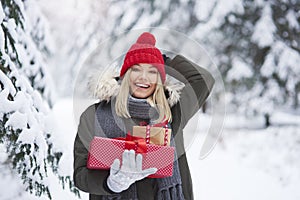 Woman holding stack of Christmas presents