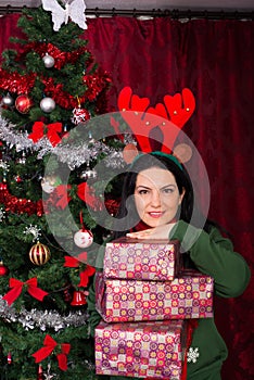 Cheerful woman holding stack of presents