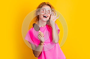 cheerful woman with icelolly ice cream isolated on yellow. woman with icelolly ice cream photo