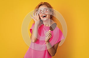 cheerful woman with icelolly ice cream isolated on yellow. woman with icelolly ice cream