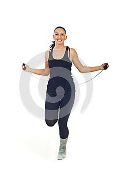 Cheerful woman leaping jump rope photo