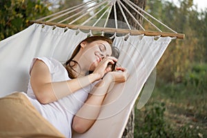cheerful woman lies in a hammock rest nature fresh air
