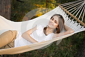 cheerful woman lies in a hammock rest nature fresh air