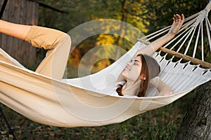 cheerful woman lies in a hammock rest nature fresh air