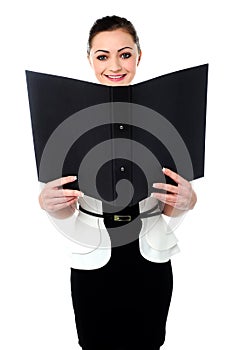 Cheerful woman looking at the file in hands