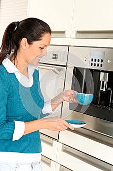 Cheerful woman making coffee machine kitchen cup