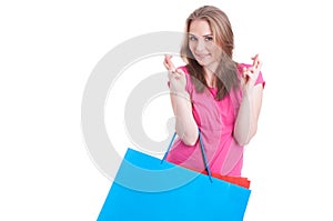 Cheerful woman making wish and luck sign with both hands