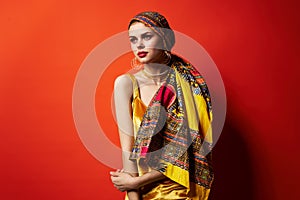 cheerful woman in multicolored turban attractive look Jewelry red background