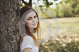 cheerful woman near the tree nature Sun freedom journey photo