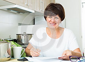 Cheerful woman paying bills
