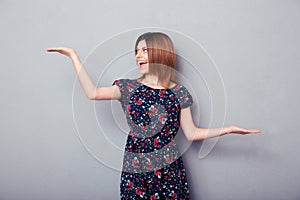 Cheerful woman presenting copyspace on palms