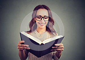 Cheerful woman reading smart book