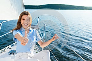 Cheerful Woman Sailing On Yacht Gesturing Thumbs-Up Approving Sailboat Tour