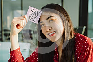 Cheerful woman say yes paper photo