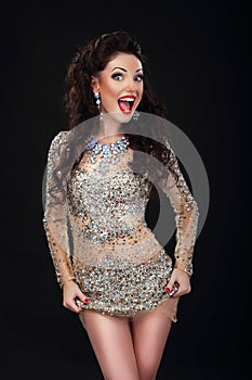 Cheerful Woman in Shiny Silver Stagy Dress Having Fun photo