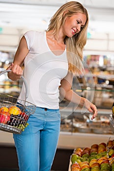 Cheerful woman shopping in grocery