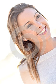 Cheerful woman smiling on white background