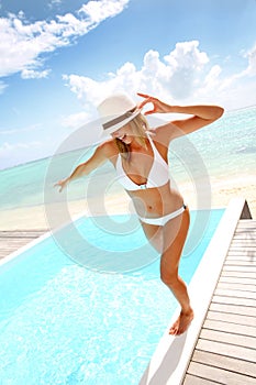 Cheerful woman standing by pool