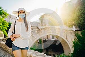 Cheerful woman travelling to Europe amid COVID-19. Visiting local tourist destinations, Old Bridge in Mostar, Bosnia and