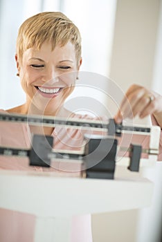 Cheerful Woman Using Balance Weight Scale