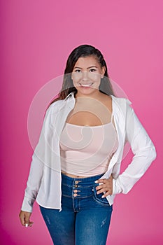 Cheerful woman in white shirt, pink background.