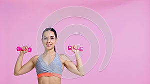 cheerful woman working out with dumbbells