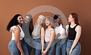 Cheerful women of different body types and ages standing together in studio