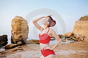Cheerful wondered beautiful pin up girl in swimsuit posing