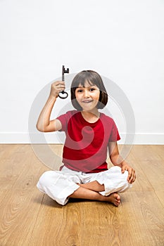 Cheerful kid showing key for success, creativity and inspiring career