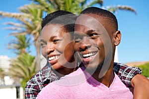 Cheerful young african american couple smiling outdoors