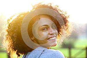 Cheerful young african american woman smiling outdoors