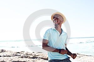 Cheerful young african man enjoying at the beach