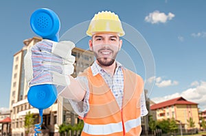 Cheerful young architect giving you the phone receiver