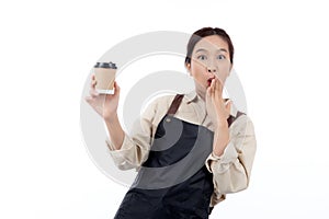 Cheerful young asian woman barista in casual work attire happily holding a takeaway coffee cup.