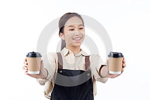 Cheerful young asian woman barista in casual work attire happily holding a takeaway coffee cup.